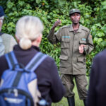 David a wildlife ranger at the Bwindi Impenetrable National Park, briefs tourists before the daily gorilla tracking adventure. Get a free price quote for the maasai mara to gorilla trekking adventure with Nandi Adventures