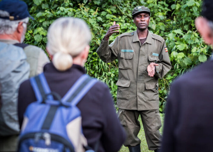 David a wildlife ranger at the Bwindi Impenetrable National Park, briefs tourists before the daily gorilla tracking adventure. Get a free price quote for the maasai mara to gorilla trekking adventure with Nandi Adventures