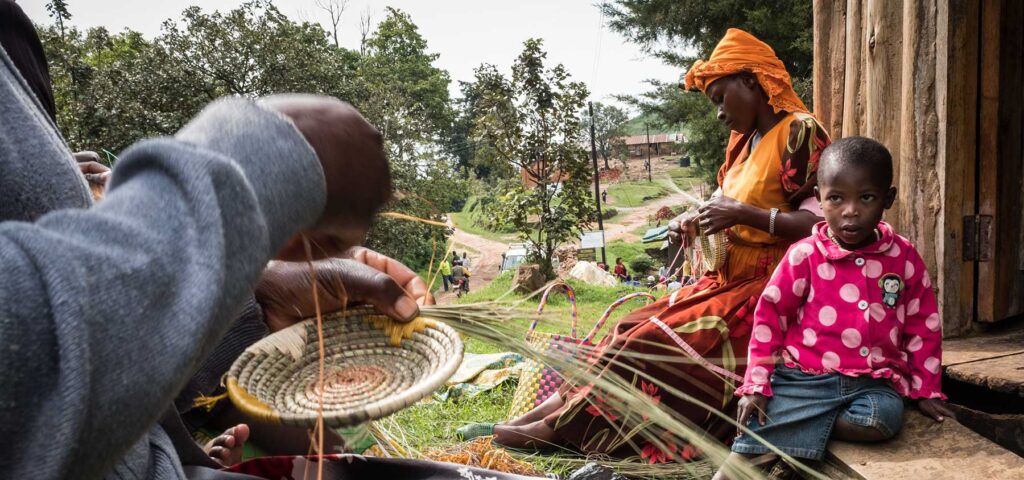 Women weave baskets that will be sold to tourists visiting Bwindi Impenetrable National Park in Uganda. Tourism and conservation have positively changed the lives of local communities - Nandi Adventures